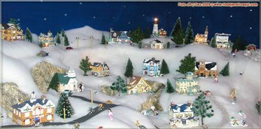 maquete natalina com inúmeras casas na neve